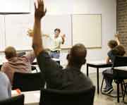 person raising hand in class