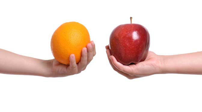 Two students receiving pell grants holding an orange and a red apple against a white background.