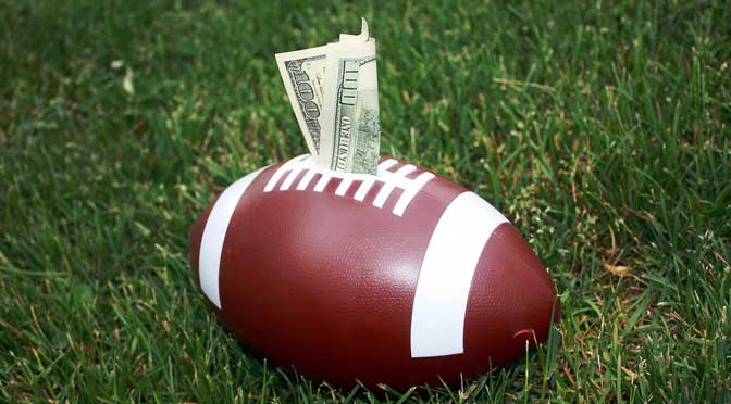 football with money representing college athletic scholarships