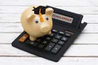 Piggy bank on calculator representing best public colleges for merit aid