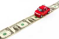 car driving on money representing expensive out of state tuition