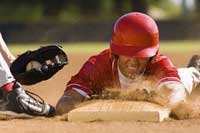 player sliding into base representing how to get recruited to play college baseball