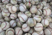 Many baseballs representing How Many Colleges to Target to Play College Baseball