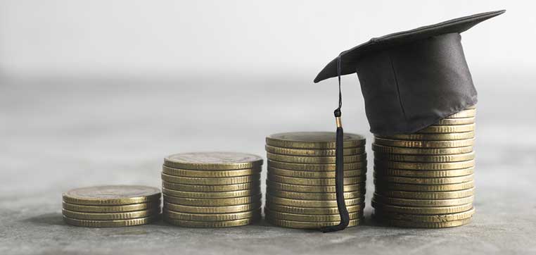 Stacks of coins with graduation hat representing Best Public Universities for Low Income Students