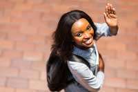 Student waving goodbye representing ways to expand your education with off campus study