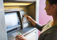 student using atm representing importance of teen checking accounts