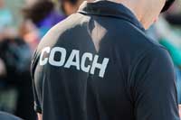 person with coach shirt representing d1 coaches recruiting athletes