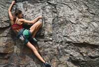 woman rock climbing representing hardest colleges to get into