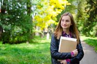 Female college student considering what's wrong with affordable colleges